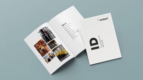 Produktbroschüre von Steimel, geöffnet und geschlossen, mit Titel "ID – Sitzmöbel mit Identität" und hochwertigem Innendesign.