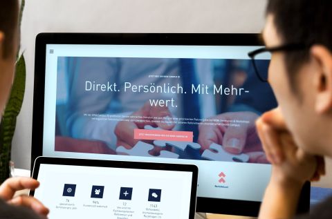 Zwei Personen betrachten die WSW Campus Website mit Fokus auf Services und Vorteile auf Monitor und Tablet